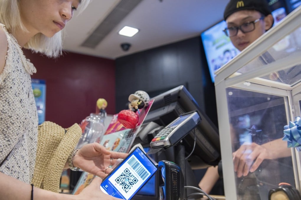 A customer uses her smartphone to pay at a McDonald’s in Shanghai. Pictures: Zigor Aldama