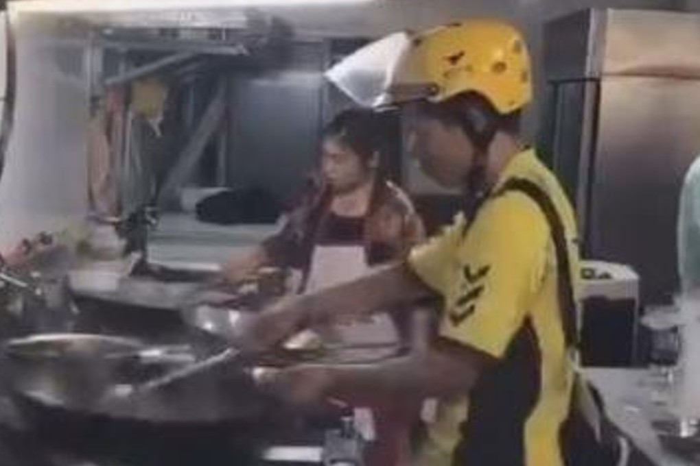 The mystery man prepares food in a commercial kitchen. The company he works for has said it will investigate the incident. Photo: Handout