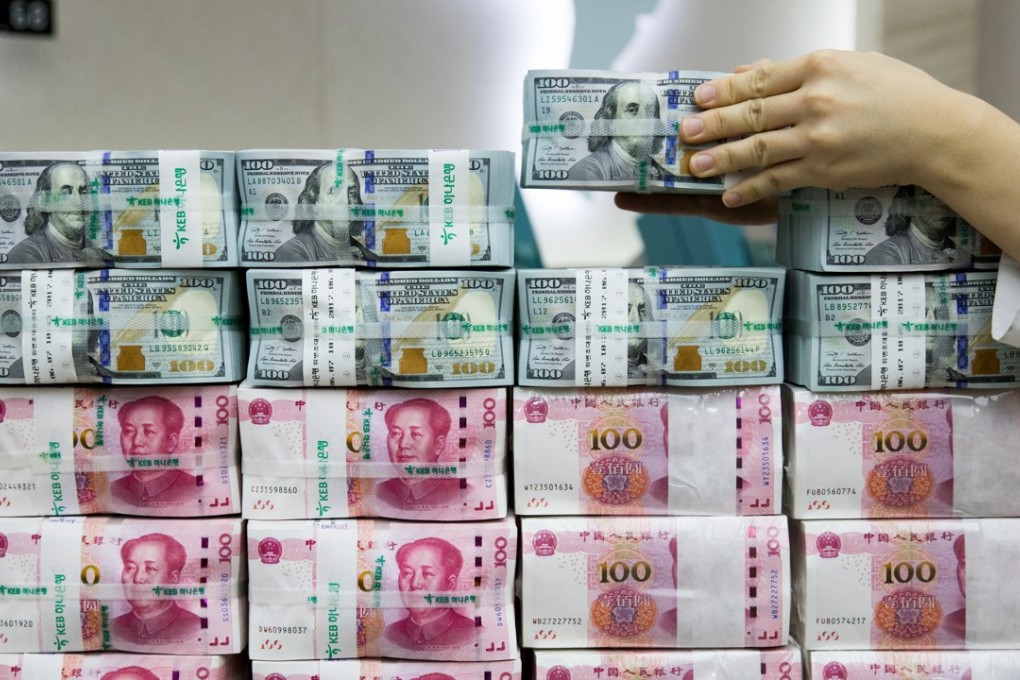 US 100-dollar banknotes and Chinese 100-yuan notes at a bank in Korea. Analysts said China is not so worried about the recent rise in the value of the yuan, instead seeing it as an opportunity to push financial reform. Photo: Bloomberg