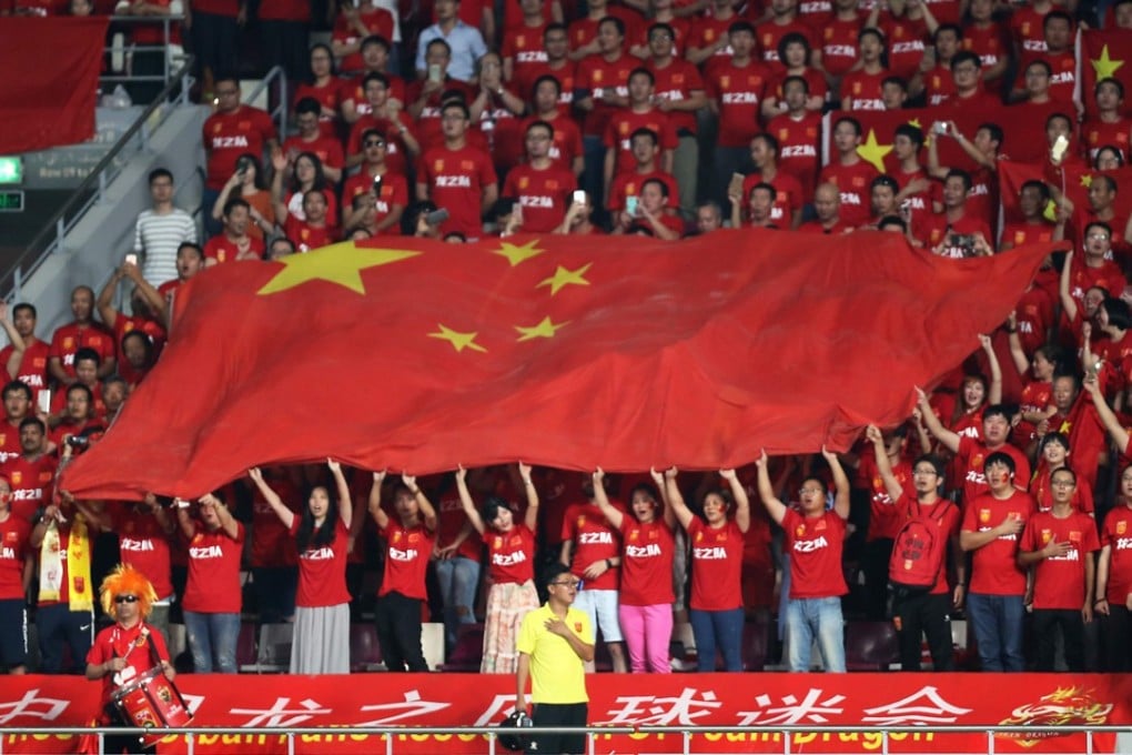 Fans hold up the flag of China as the national anthem plays before the start of the Fifa World Cup 2018 qualification match against Qatar, in Doha on September 5. Photo: AFP
