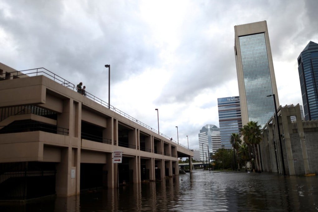 A couple overlooks floodwaters after Hurricane Irma in Jacksonville, Florida, on Monday. Photo: Reuters