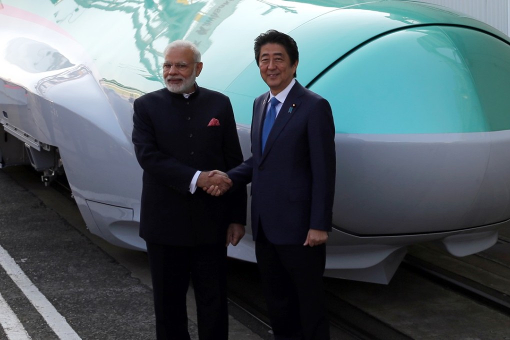 Narendra Modi, India's prime minister and Shinzo Abe, Japan's prime minister, right, shake hands in front of an E5 series Shinkansen bullet train in Kobe, in 2016. File photo: AFP