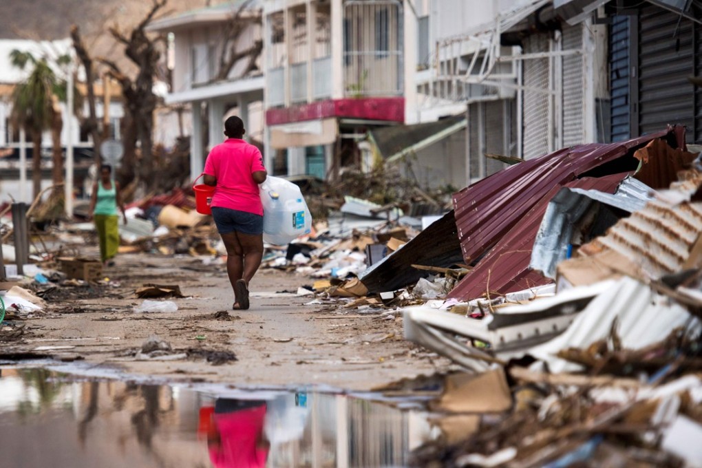 A woman walks down a street on the French Caribbean island of St Martin after it was hit by Hurricane Irma. Photo: AFP