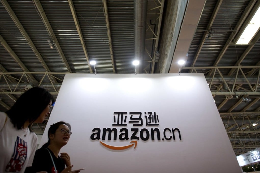 Visitors walk past a logo for Amazon China at the Beijing International Book Fair in Beijing. Amazon is ramping up hiring in China. Photo: AP