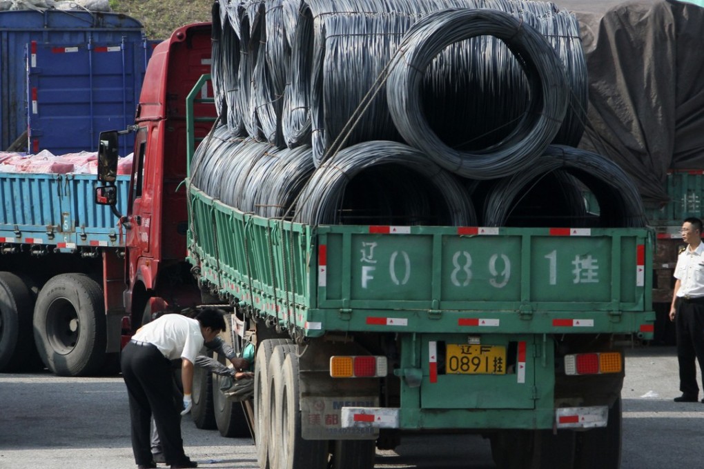 Chinese customs officials inspect trucks going to and from North Korea in Dandong, Liaoning on Monday. Photo: AP
