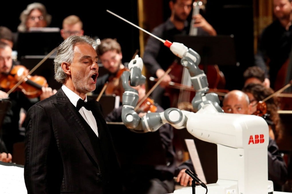 Robot YuMi conducts Andrea Bocelli and the Lucca Philharmonic Orchestra at the Verdi Theatre in Pisa. Photo: Reuters