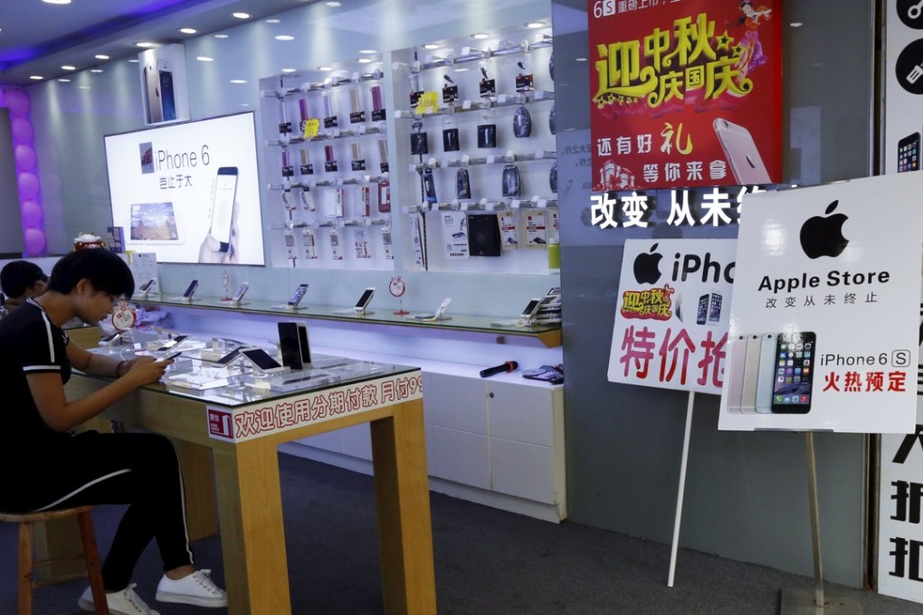 A store with an “Apple Store” sign is seen in Shenzhen on September 21, 2015. On a bustling street, more than 30 stores carrying Apple's iconic white logos peddle pre-orders for the new iPhone. But the US company only has one official store in Shenzhen and five authorised dealers in the area. Most of the stores in the roughly 1km shopping corridor are unauthorised “fakes” - although they sell genuine Apple products - and their numbers have mushroomed ahead of the release on September 25, 2015 of the iPhone 6S and iPhone 6s Plus. Photo: REUTERS