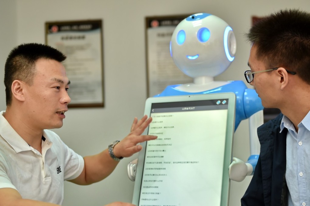 Clients interact with intelligent robots ‘Fa Mengmeng’ and ‘Lyu Mengmeng’ at a law firm in Yuncheng, Shanxi province. Photo: Xinhua