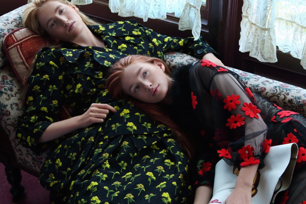 Olivia (left) wears black jacket with embroidered yellow flowers (US$2,560) and matching skirt (US$1,702), both by Simone Rocha from I.T. Sarah wears sheer dress with red embroidered flowers by Simone Rocha from I.T (inquiries: 2890 7012). Hat (US$666) by Loewe. Photography: Olivia Tsang