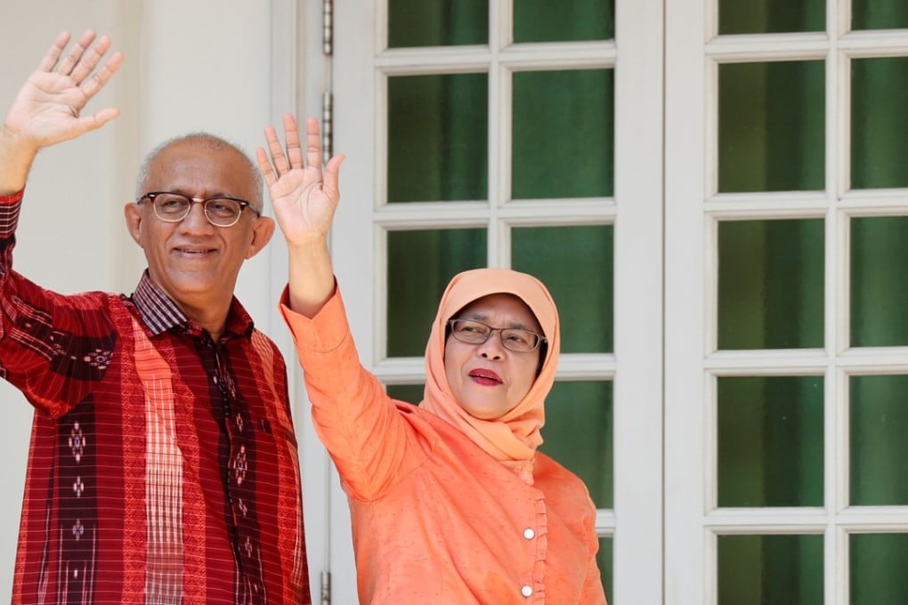 Former parliamentary speaker Halimah Yacob, who was named Singapore’s new president, waves to supporters with her husband Mohammed Abdullah Alhabshee. Photo: Reuters