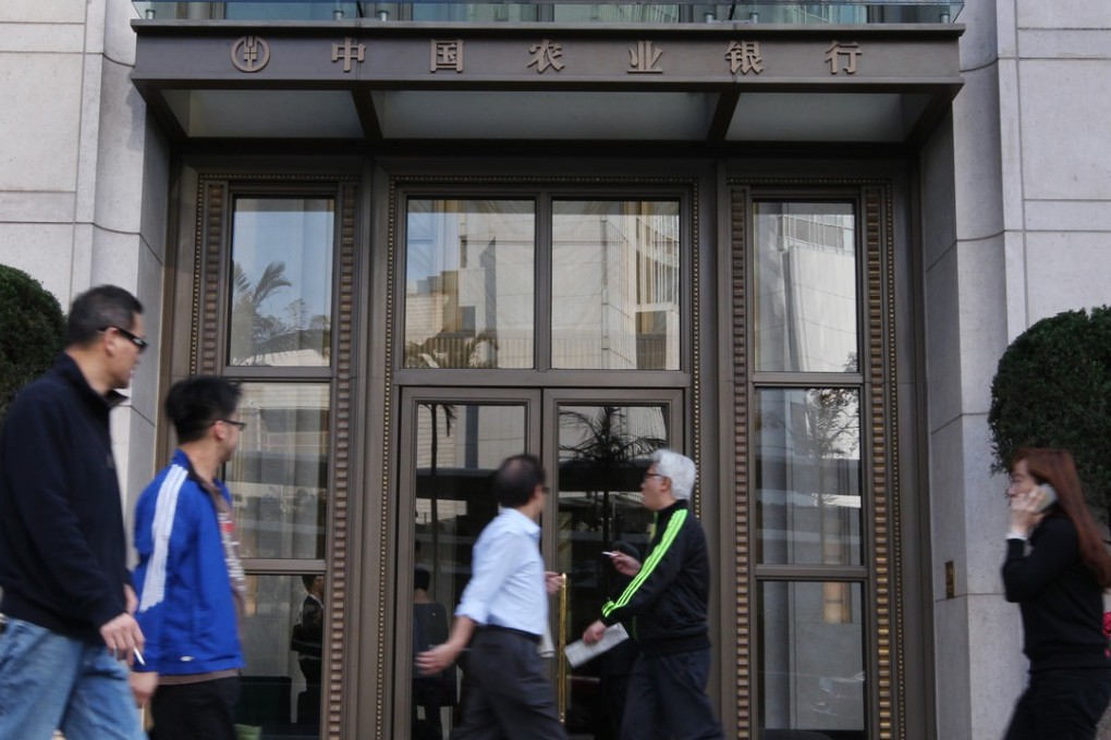 People walk by the Agricultural Bank of China building in Central. Photo: SCMP Pictures