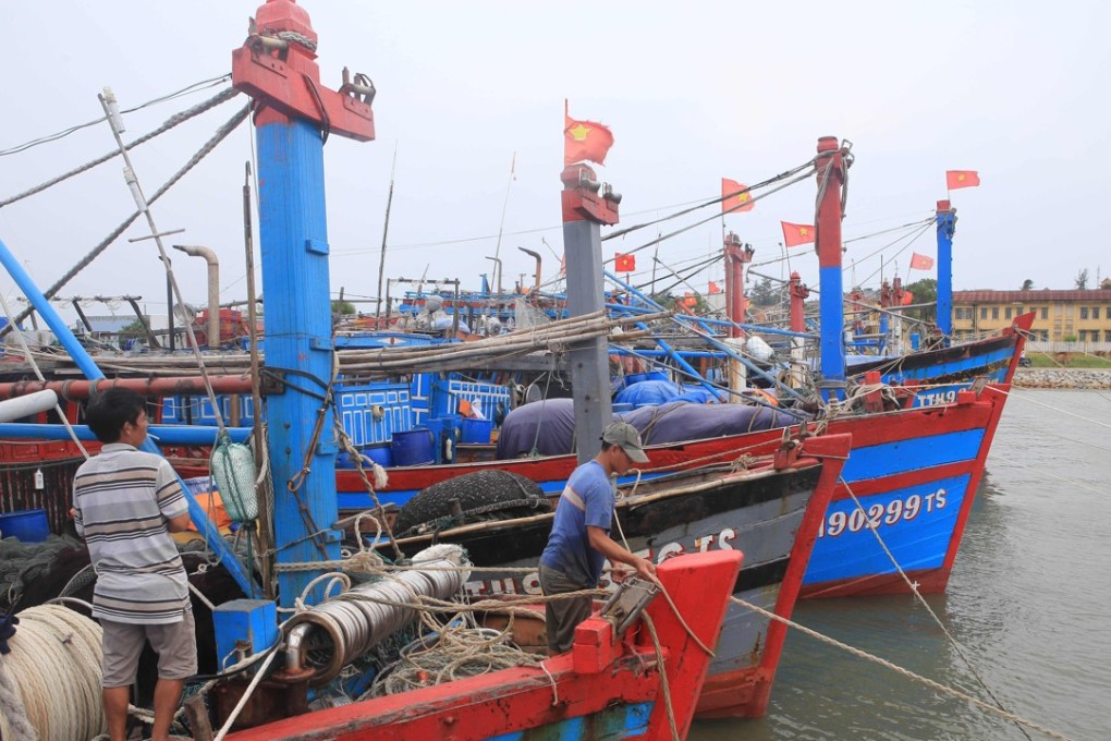 Fishermen tie up their fishing boat anchored at a fishing port in the central province of Thua Thien Hue. Photo: AFP
