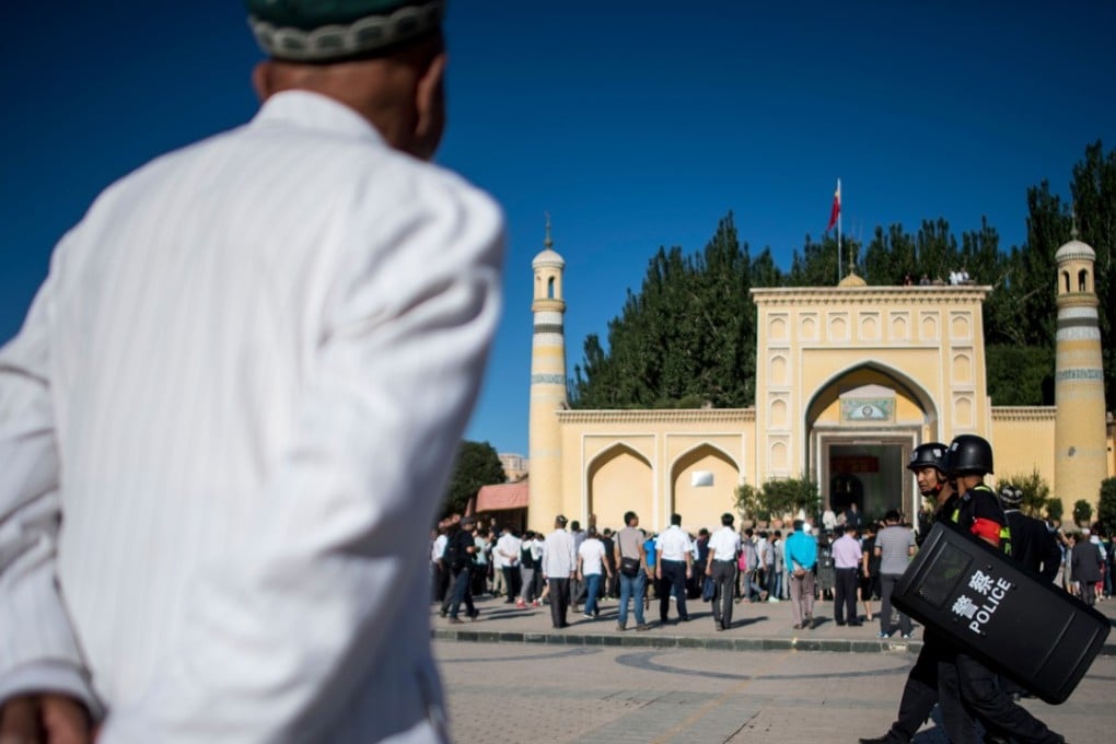 Muslims arrive at the Id Kah Mosque for morning prayer on Eid al-Fitr in the old town of Kashgar in Xinjiang in June. Beijing says restrictions and a heavy police presence in the region seek to control the spread of Islamic extremism and separatist movements. Photo: AFP