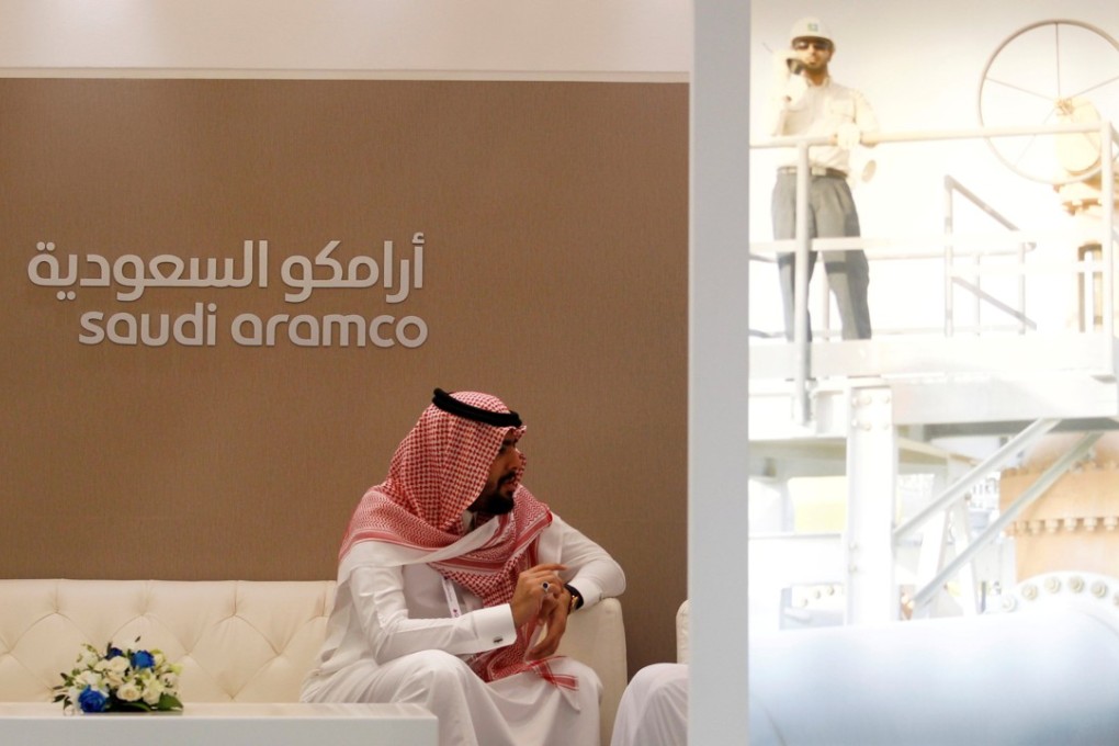 A Saudi Aramco employee sits in the area of its stand at the Middle East Petrotech 2016, an exhibition and conference for the refining and petrochemical industries, in Manama, Bahrain on September 27, 2016. Photo: Reuters