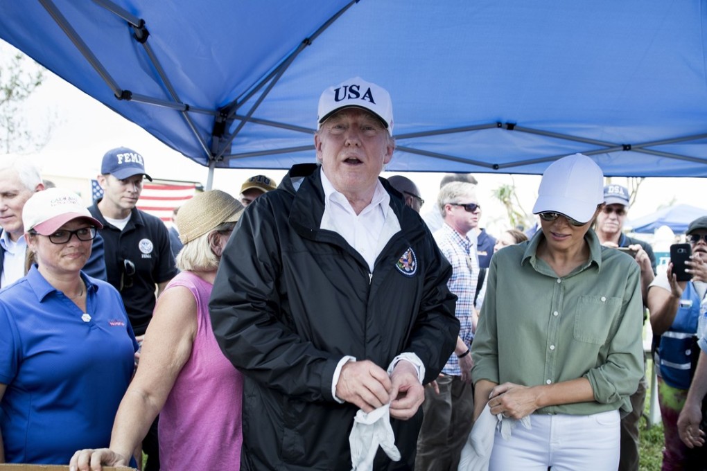 US President Donald Trump and US First Lady Melania Trump put on gloves to hand out food while touring the Naples Estates neighbourhood damaged during Hurricane Irma on September 14, 2017 in Naples, Florida. Photo: AFP