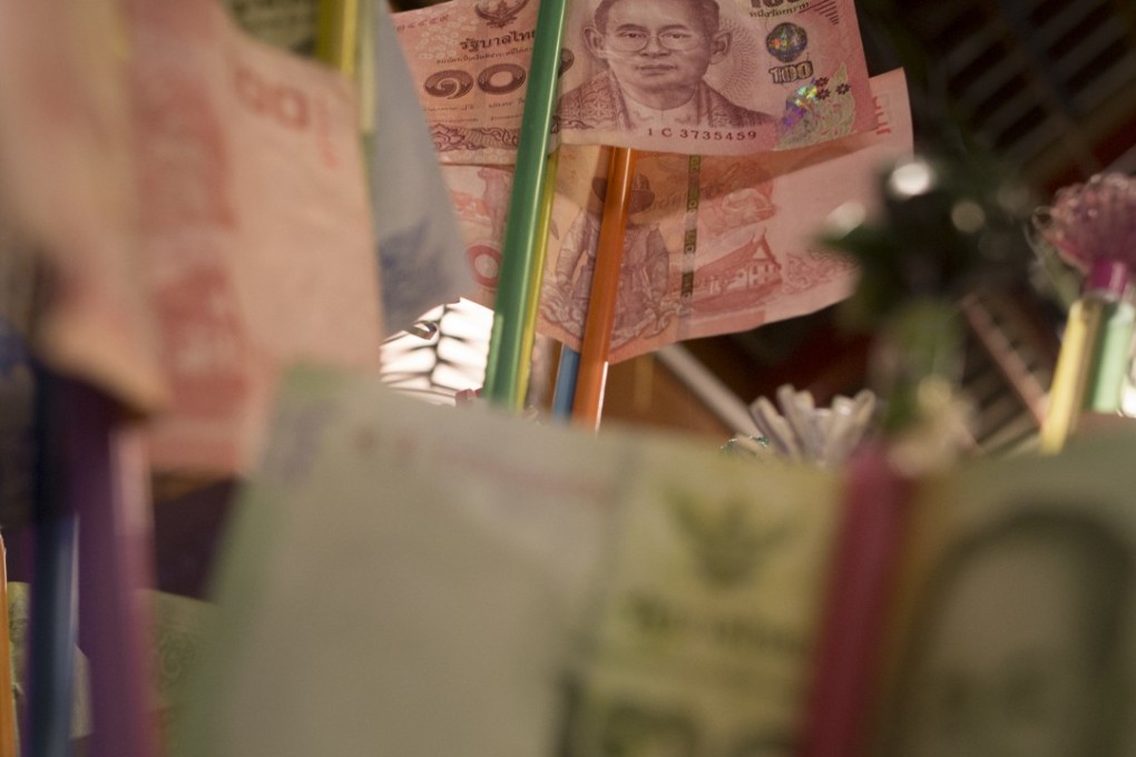 Thai banknotes on display at a restaurant in Bangkok, before they are donated to a temple. Photo: May Tse