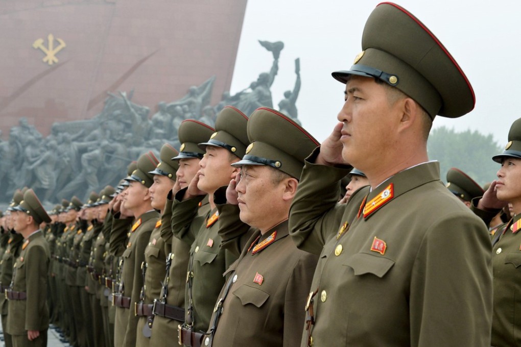 North Korean soldiers salute at Munsu Hill in Pyongyang on Saturday to mark the 69th anniversary of the country's founding. Photo: Kyodo News via AP