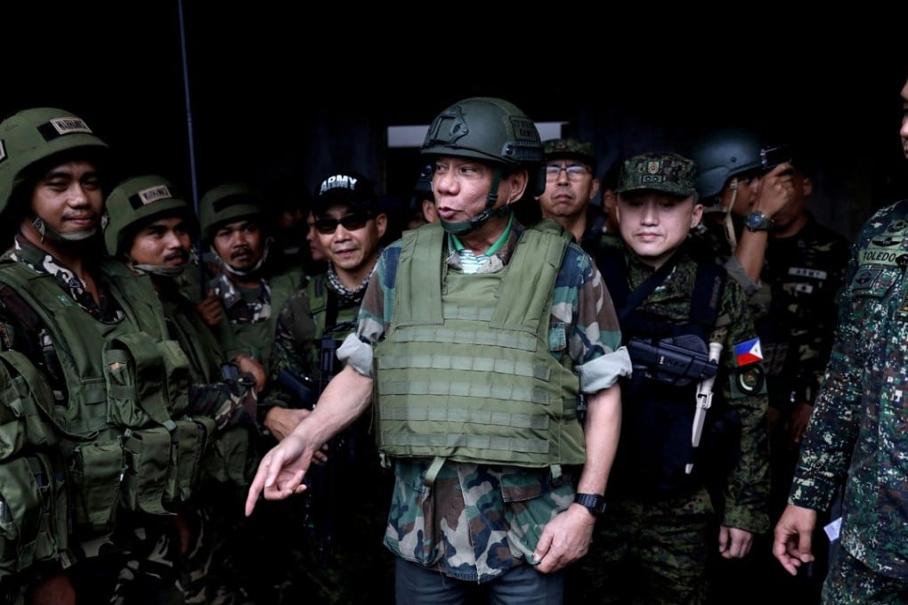 Philippine President Rodrigo Duterte wears a bulletproof vest and a helmet as he gives a pep talk to troops fighting the extremist Maute group in Marawi. Photo: Reuters