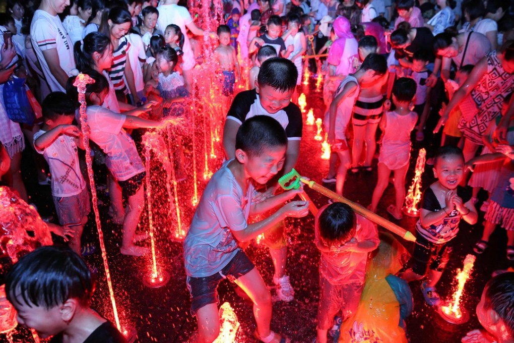 Children and adults play in a fountain to cool off during a heatwave in Yangzhou, China's eastern Jiangsu province. Parts of China also have seen record temperatures in recent weeks, in what has been a torrid summer so far for much of the country, while large areas of south-central China have endured raging floods from torrential rain. Photo: AFP