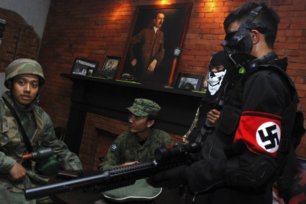 Indonesian customers in second world war military uniforms at Soldatenkaffee in Bandung before the cafe was closed down for a second time in January this year. Photo: AFP