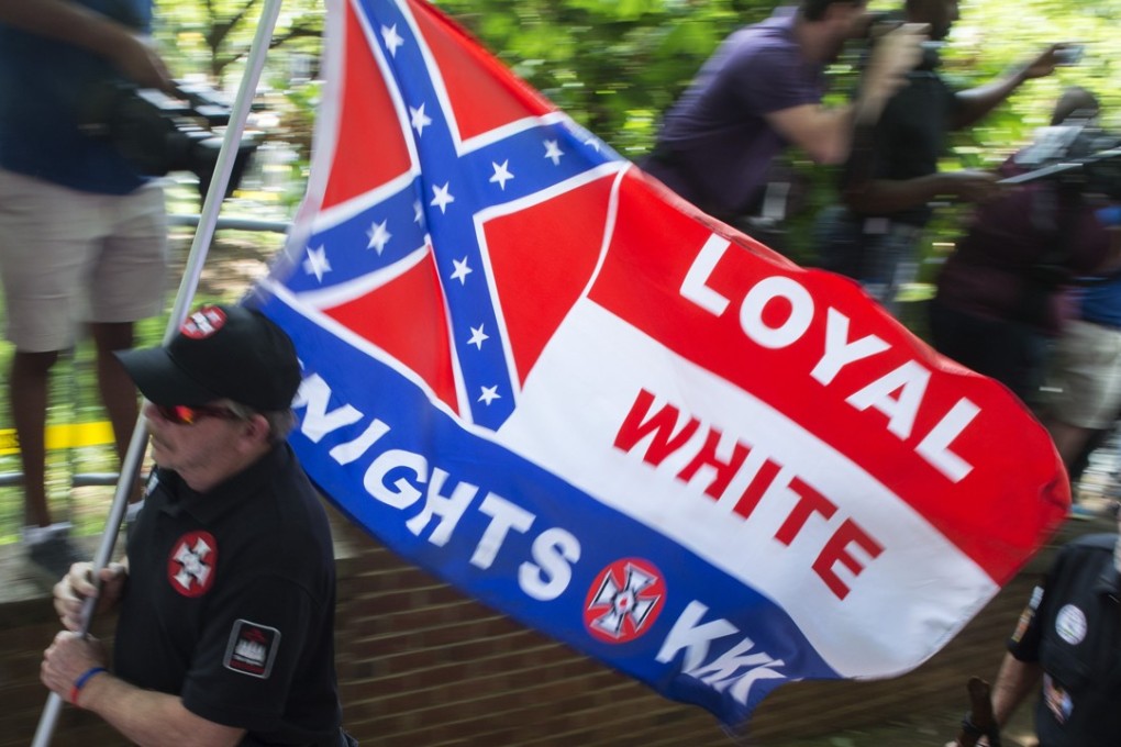A photo taken on July 8 shows members of the Ku Klux Klan arriving for a rally, calling for the protection of Southern Confederate monuments, in Charlottesville, Virginia. Photo: AFP