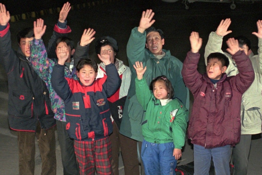 North Korean defectors wave after arriving in South Korea by boat in January 1997. Picture AP