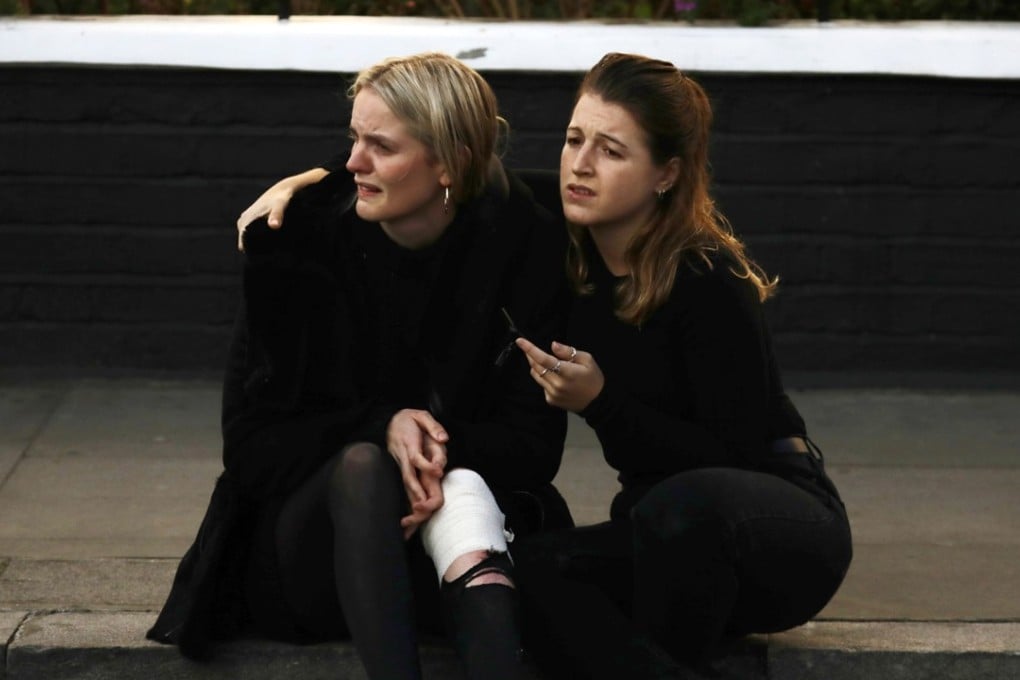 An injured woman sits and cries on the pavement outside Parsons Green station in London after a bomb was detonated on a packed commuter train. Photo: Reuters