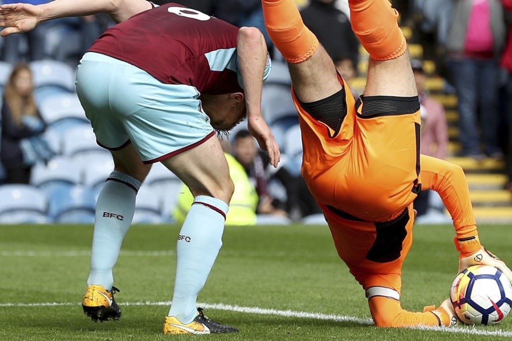 Burnley goalkeeper Tom Heaton catches the ball before landing awkwardly on his shoulder during the English Premier League soccer match against Crystal Palace at Turf Moor, Burnley, England. The injury to the English keeper will keep him sidelined for months. Photo: PA via AP