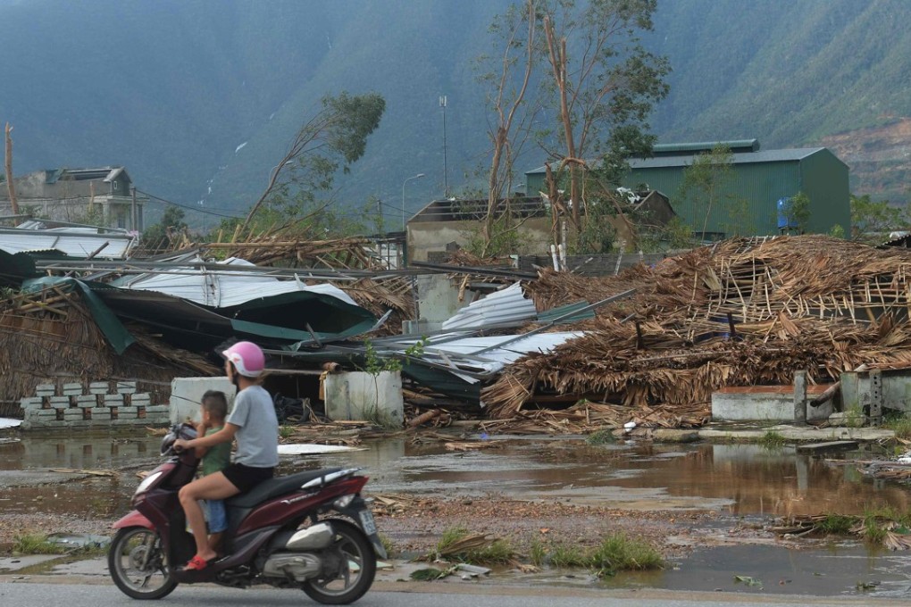 A motorcyclist rides past a row of destroyed homes in Ky Anh town, in the central Vietnam province of Ha Tinh after Typhoon Doksuri. Photo: AFP