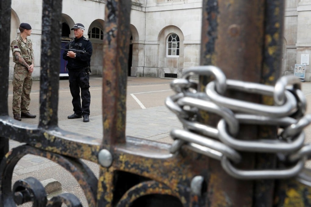 A police officer and a soldier stand at the entrance to Horse Guards Parade after it was closed because of the heightened security following an explosion on an underground train on Friday in London. Photo: Reuters