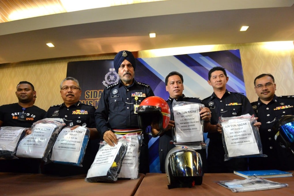 Kuala Lumpur police chief Amar Singh and police officers display bags containing evidence from the suspects. Photo: Xinhua