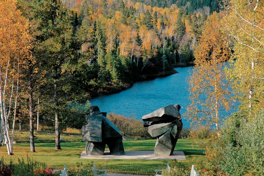 A pair of Ju Ming sculptures doubles up as framing device for a country estate in Quebec. Photo: Handout