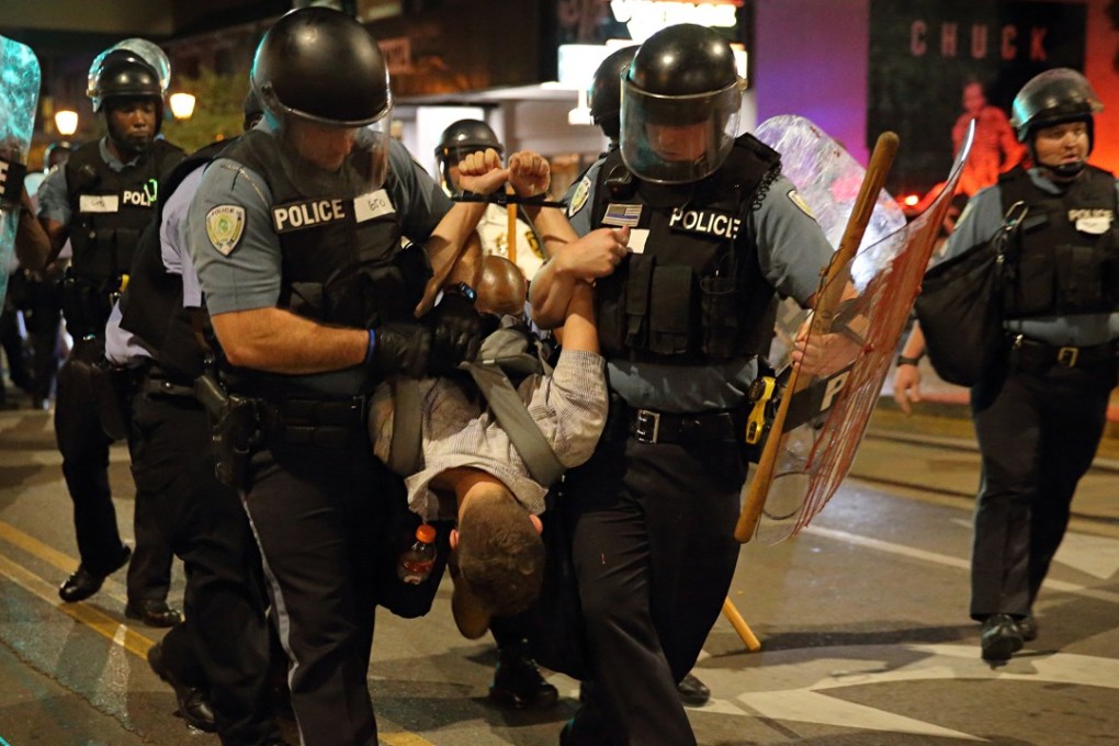 Police officers arrest a man during protests in St Louis. Photo: TNS