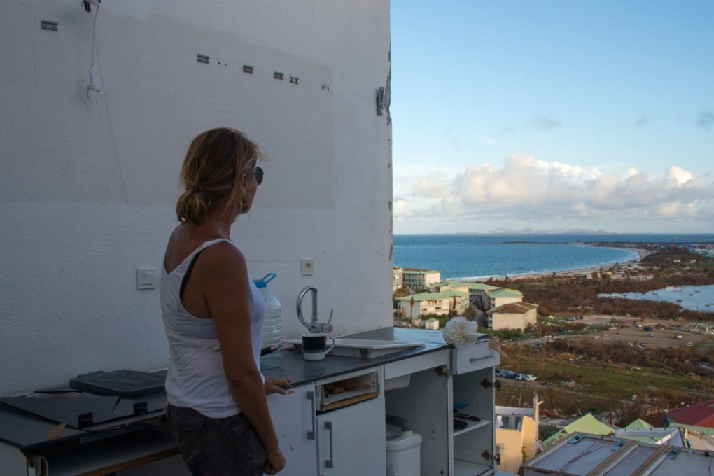 A photo taken on September 17, 2017 shows a woman standing in a room without a roof or windows at the Alizea residence in Mont Vernon, on the French Caribbean island of Saint Martin, after the passage of Hurricane Irma. Almost two weeks after Hurricane Irma slammed into St Martin, the island must brace for Hurricane Maria roaring in this week. Photo: AFP