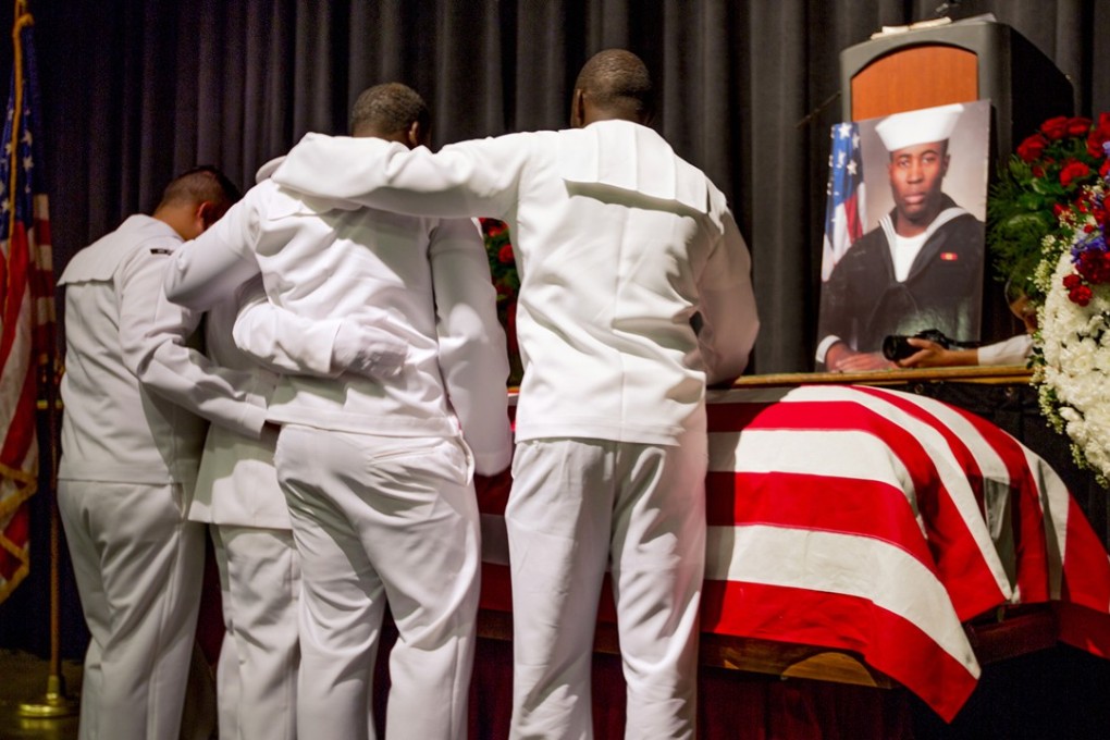 IFour sailors mourn at the casket of Corey Ingram before his funeral, at the Mid-Hudson Civic Center in Poughkeepsie, New York, on September 12. Ingram was among the 10 US sailors killed when the USS John S. McCain, collided with an oil tanker off Singapore on August 21. Photo: AP