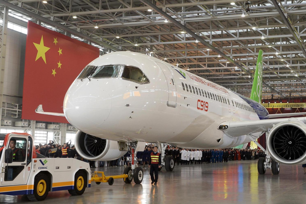 The first C919 passenger jet made by the Commercial Aircraft Corporation of China (Comac) is pulled out next to a Chinese national flag during a news conference at the company's factory in Shanghai in 2015. Photo: China Daily/Reuters