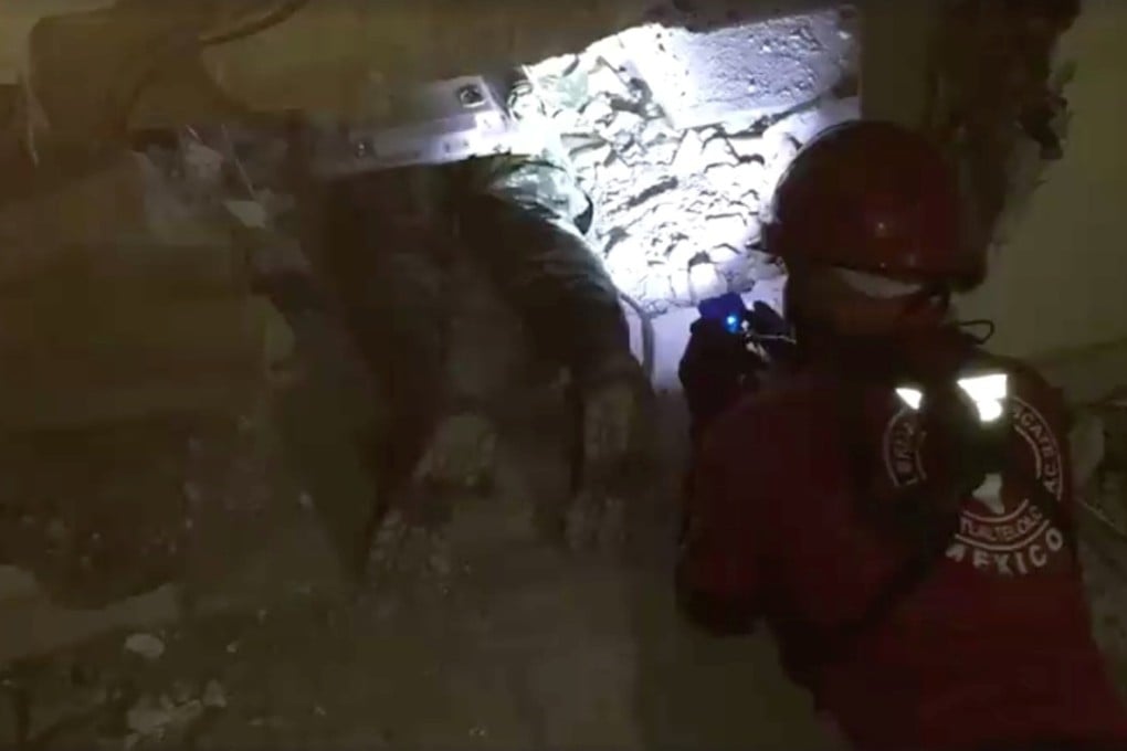 Members of Los Topos rescue brigade search for people in a fallen building in Mexico City on Wednesday. Photo: Reuters