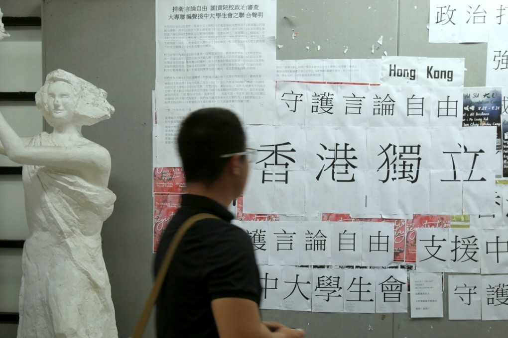 A student looks at a printout in Chinese which reads “Hong Kong Independence” displayed at City University. Photo: Reuters