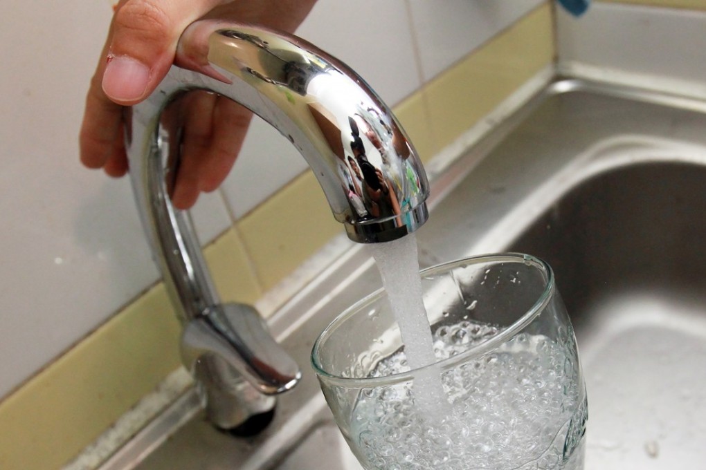 Tap water samples are taken from a flat at public housing Kai Ching Estate in Kai Tak. Photo: May Tse