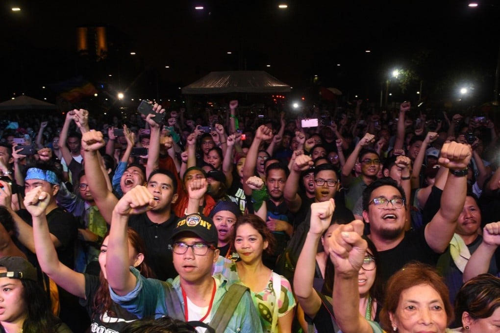Demonstrators protesting against Philippine President Rodrigo Duterte raise their fists at recent rallies in Manila. But despite the public show of force, a recent survey has shown more than three-quarters of Filipinos support the president. Photo: AFP