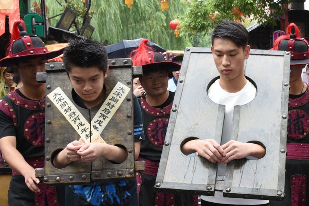 Two tourists ‘punished’ at the Hangzhou theme park. Photo: Handout