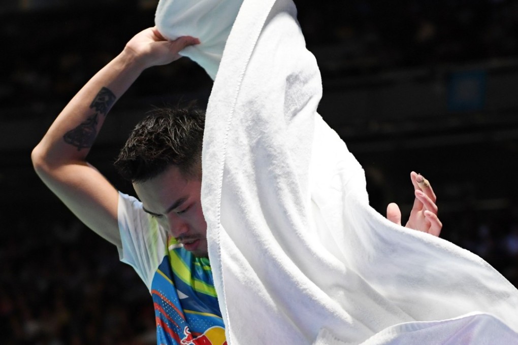 Sweet surrender: China’s Lin Dan wraps himself with a towel during his quarter-final match against South Korea’s Son Wan-ho at the Japan Open. Photo: AFP