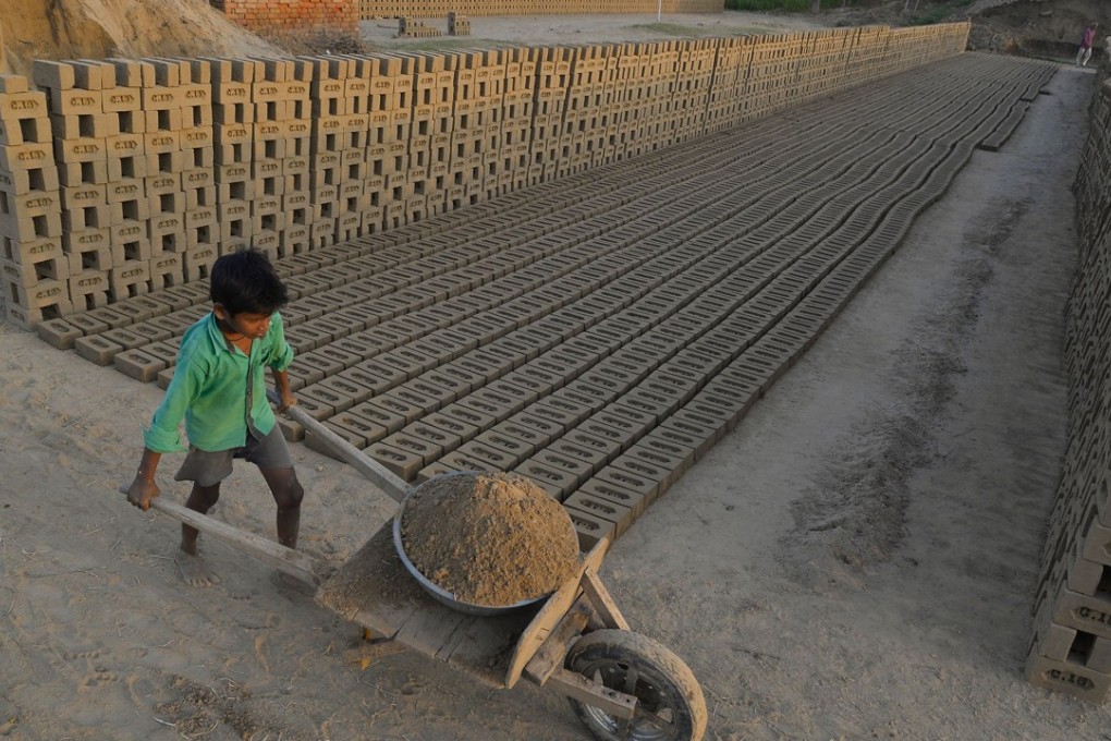 An Indian boy works in a brick kiln on the outskirts of Jalandhar on September 18. Many brick kiln workers in India are trapped in a cycle of bonded labour and regularly cheated out of promised wages, according to anti-slavery groups. Photo: AFP