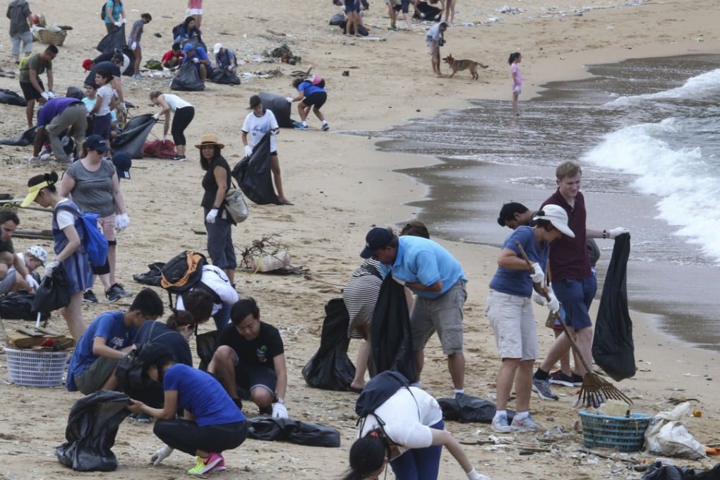 Volunteers pick up garbage on the beach near Shek O village. Photo: David Wong