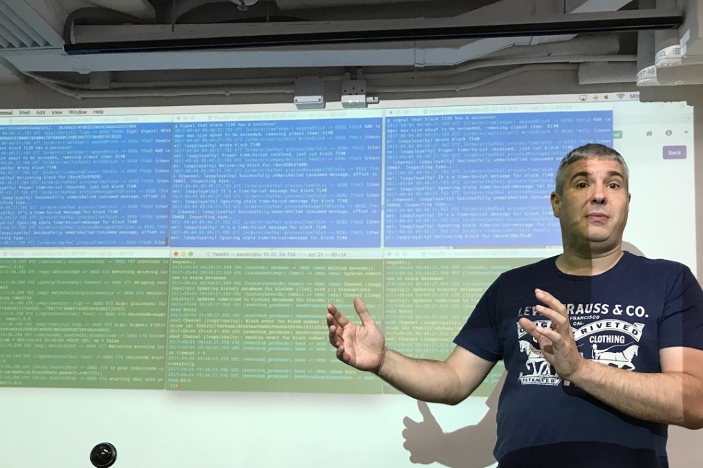 Nick Murray, co-founder and chief technology officer at Hong Kong start-up PassKit, explains how transactions are recorded and validated in the company's own blockchain platform, shown on the screen behind him. Photo: Bien Perez