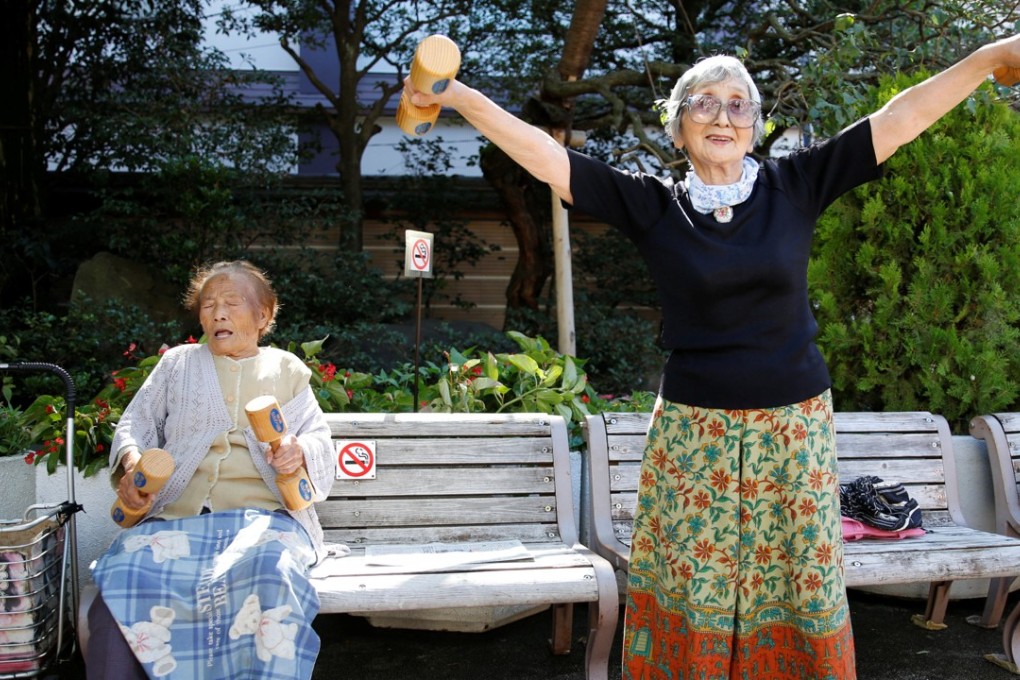 Natsu Naruse (left), who is 100 years old, joins other elderly Japanese exercising with wooden dumbbells during a health promotion event to mark “Respect for the Aged Day”, at a temple in Tokyo on September 18. Photo: Reuters