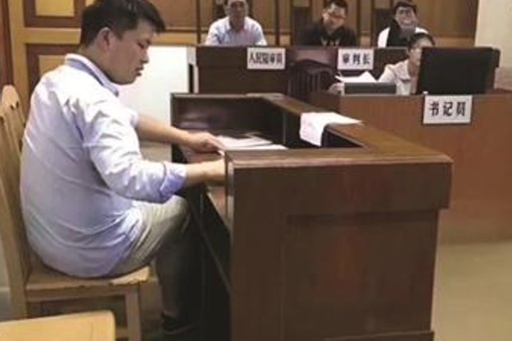 Court officials sitting in the floodwater. Photo: Handout