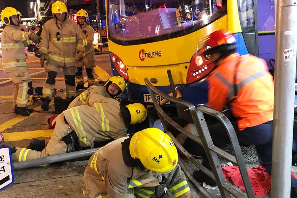 Firemen had to rescue people trapped under the bus after a Citybus double-decker ploughed onto the pavement in Sham Shui Po, killing three people and injuring dozens. Photo: Roy Issa