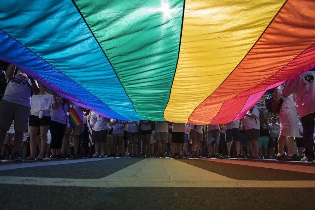 Marchers with a huge rainbow flag at an LGBT protest in Washington in the US in June. Photo: AP