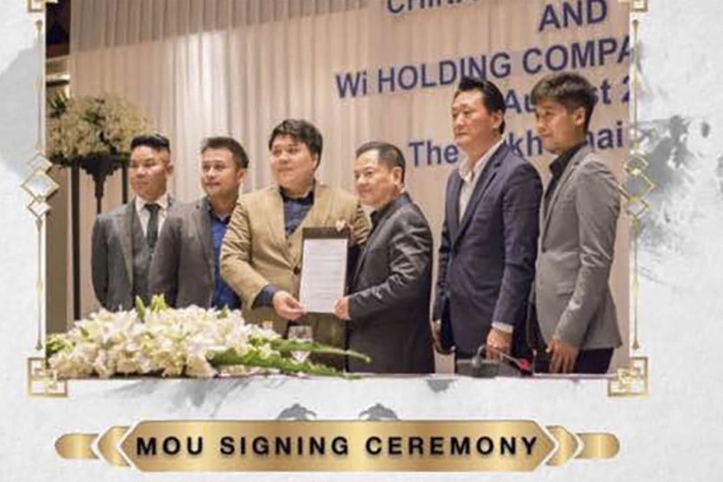 ‘Broken Tooth’ Wan kuok-koi is seen at the signing ceremony with a number of executives. Photo: Handout